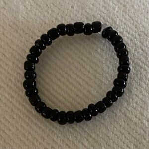 Black stretchy Beaded ring . In one size fits most .